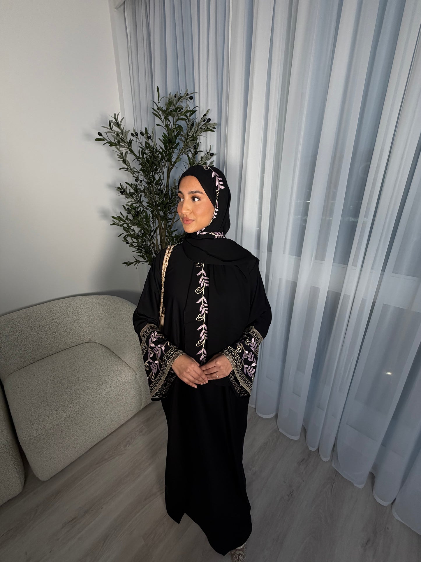 Nawara black abaya with pink embroidery and matching embroidery hijab