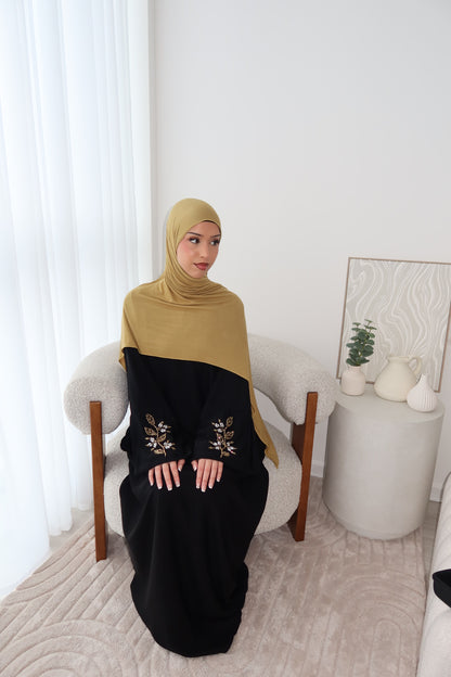 Samira black closed abaya with gold and white embellishments