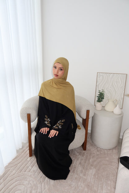 Samira black closed abaya with gold and white embellishments