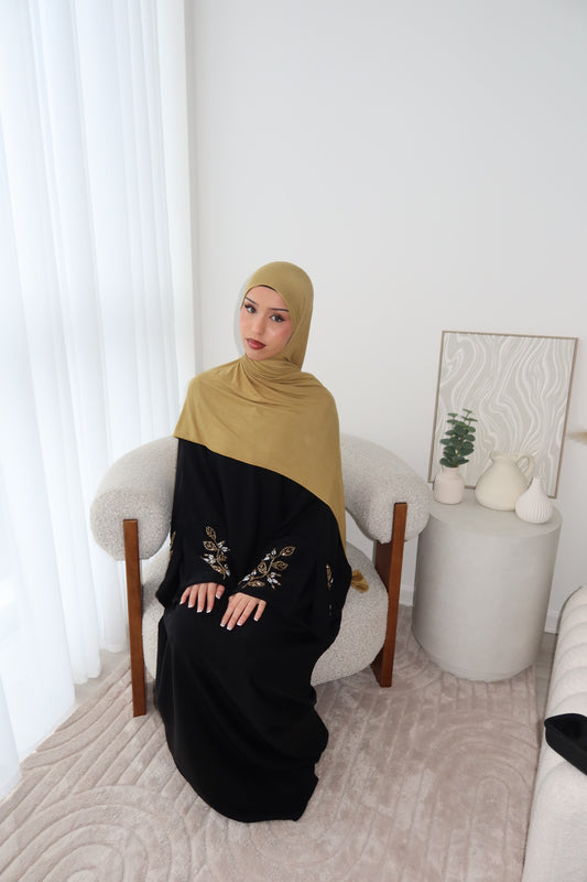 Samira black closed abaya with gold and white embellishments
