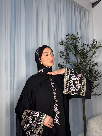 Nawara black abaya with pink embroidery and matching embroidery hijab