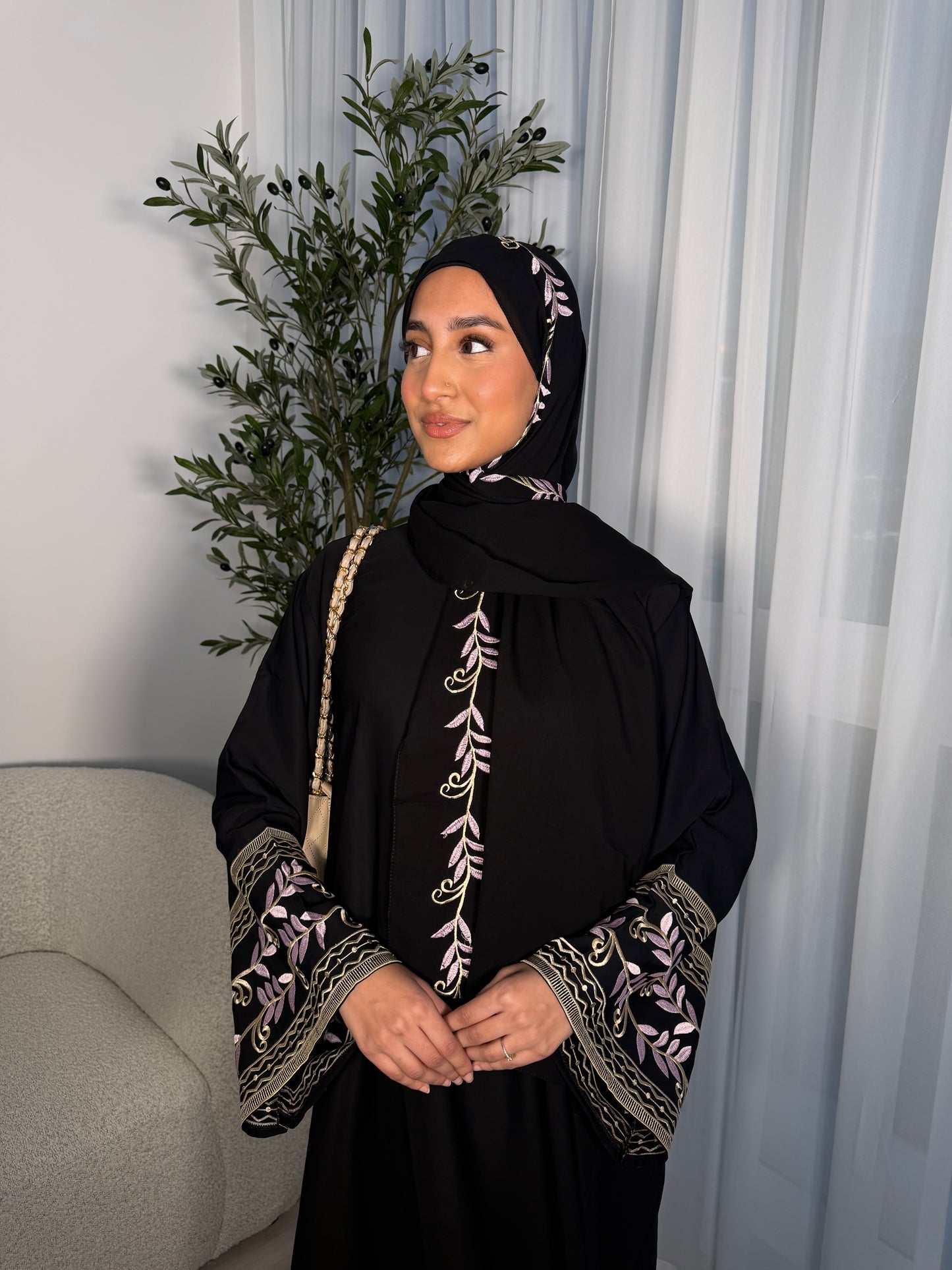 Nawara black abaya with pink embroidery and matching embroidery hijab