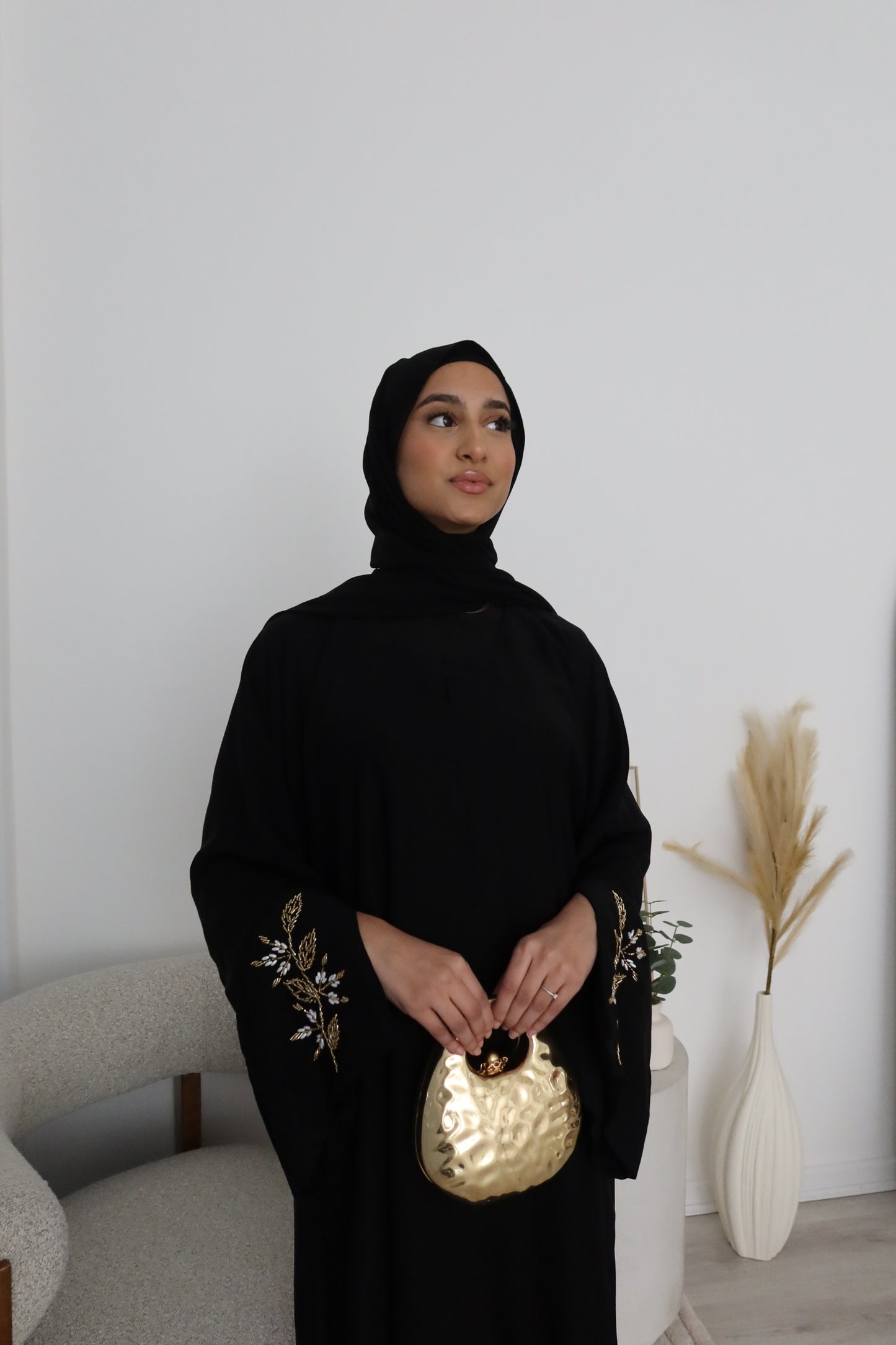 Samira black closed abaya with gold and white embellishments